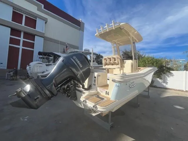 Slide: The Image of 2023 Scout 215XSF boat with Yamaha outboard motor in a marina. - 3