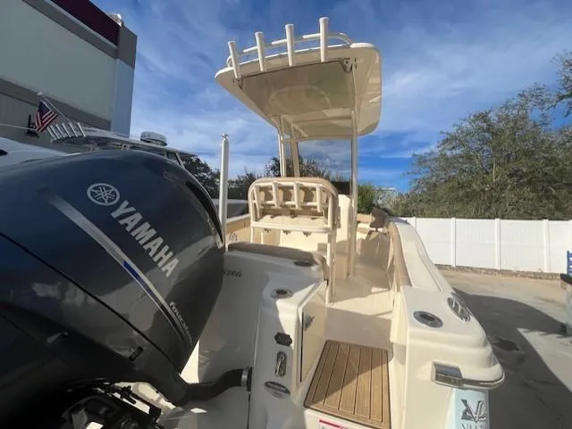 Slide: The Image of 2023 Scout 215XSF boat with Yamaha outboard motor, docked outdoors. - 4