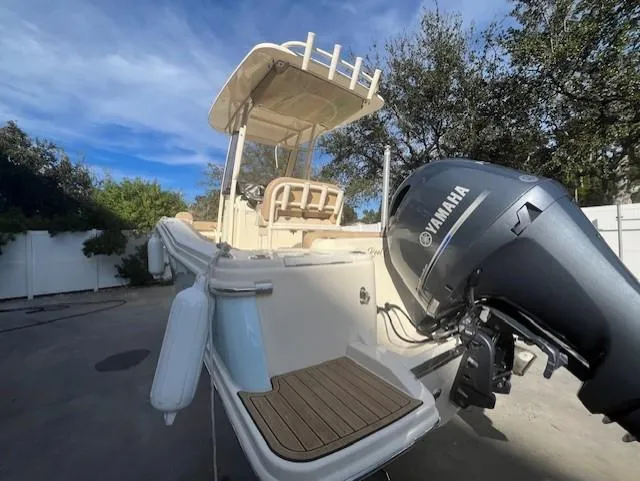 Slide: The Image of 2023 Scout 215XSF boat with Yamaha outboard motor in driveway. - 5