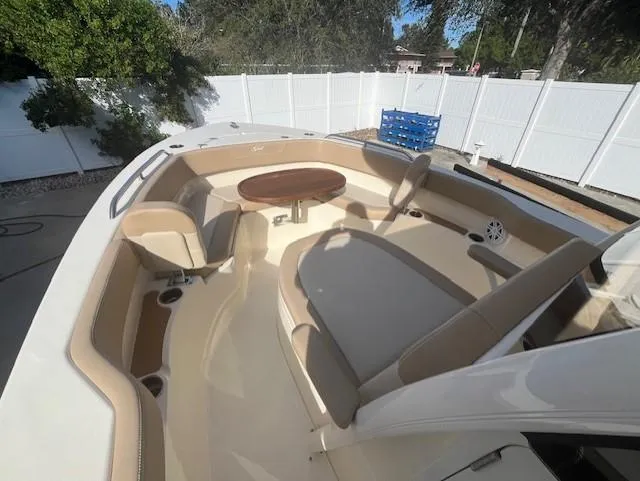 Slide: The Image of 2023 Scout 215XSF boat interior with seating and table. - 8