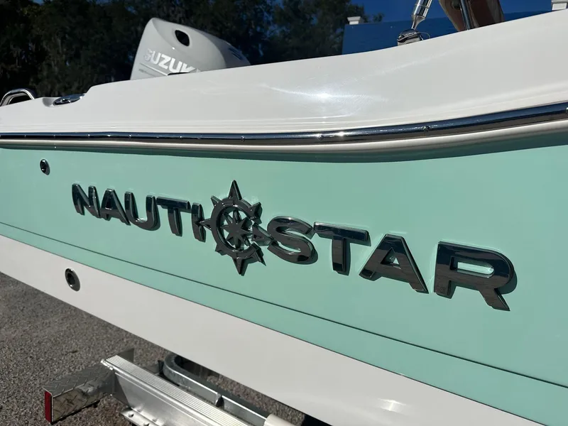 Slide: The Image of 2023 NauticStar 191 Hybrid boat side view with logo. - 11