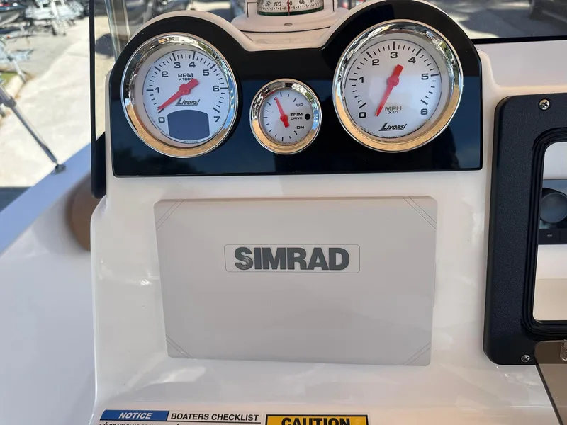 Slide: The Image of Dashboard of a 2023 NauticStar 191 Hybrid boat with Simrad display and gauges. - 12
