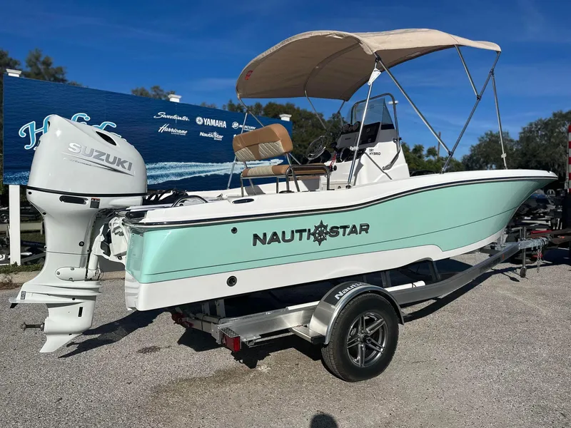 Slide: The Image of 2023 NauticStar 191 Hybrid boat with Suzuki outboard motor on trailer. - 2