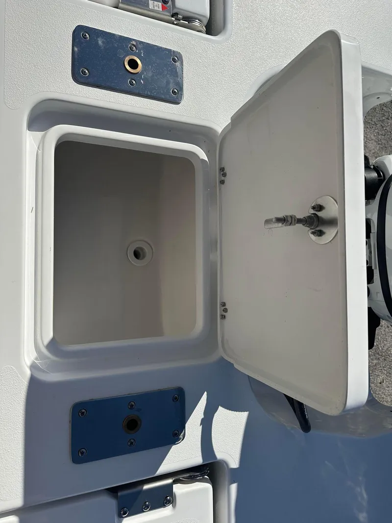 Slide: The Image of 2023 NauticStar 191 Hybrid boat storage compartment with open lid. - 8