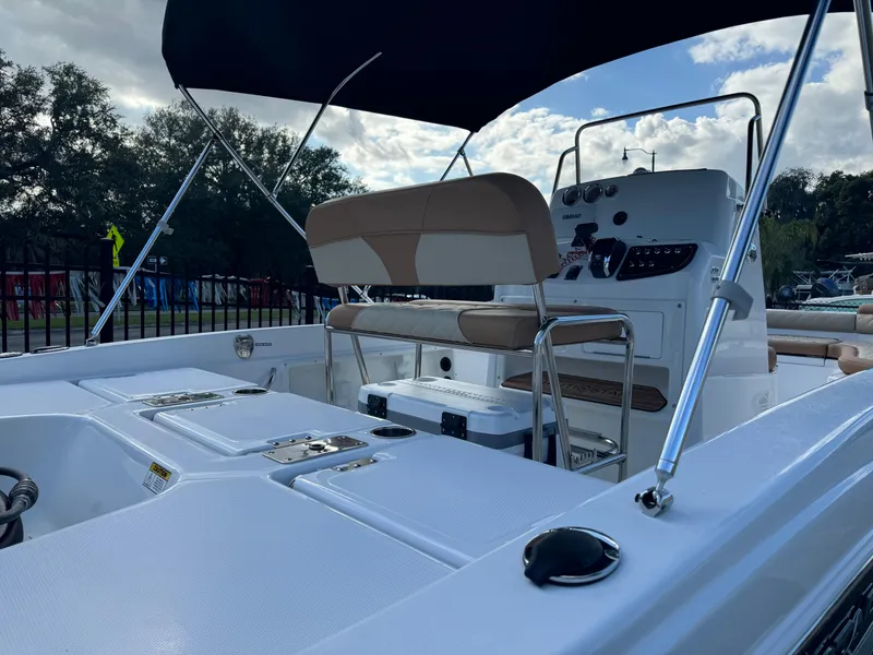 Slide: The Image of 2024 NauticStar 211 Hybrid boat interior with seating and console. - 3