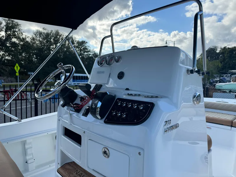 Slide: The Image of 2024 NauticStar 211 Hybrid boat console with steering wheel and controls. - 4