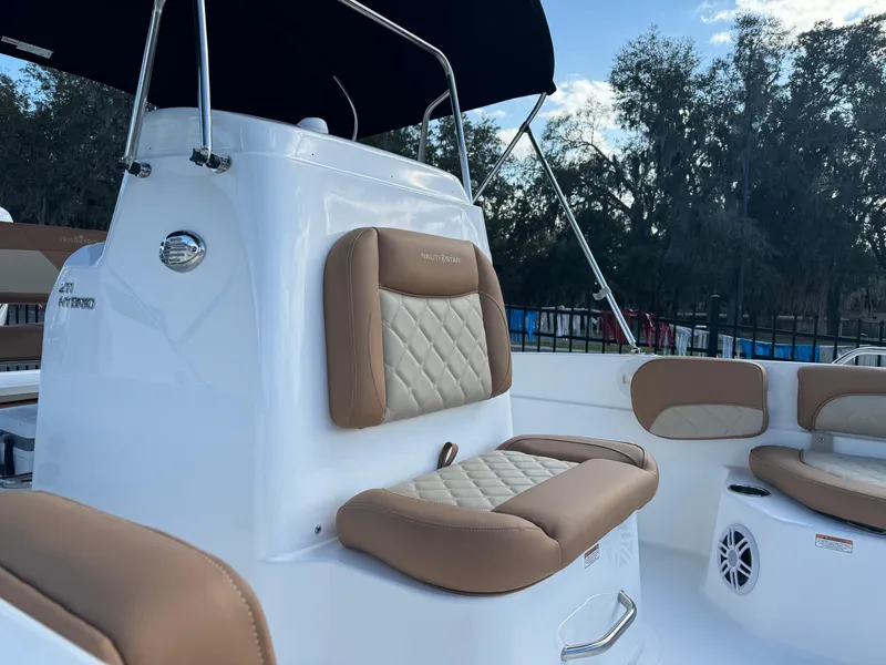 Slide: The Image of 2024 NauticStar 211 Hybrid boat with tan and white seating. - 7