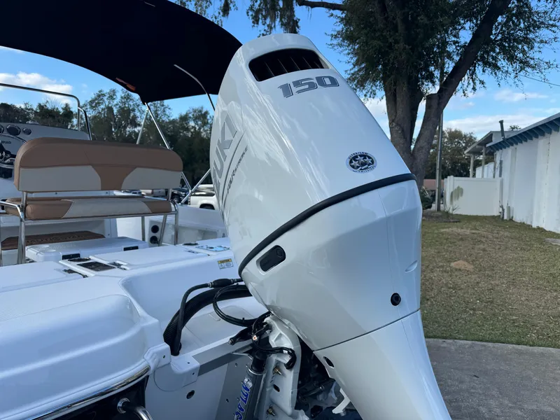 Slide: The Image of 2024 NauticStar 211 Hybrid boat with a 150 HP Suzuki outboard motor. - 9