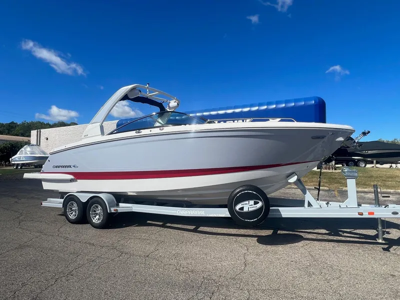 Slide: The Image of 2024 Chaparral 287 SSX boat on trailer under clear blue sky. - 0