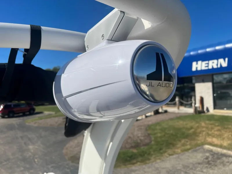 Slide: The Image of JL Audio speaker on 2024 Chaparral 287 SSX boat, outdoor dealership setting. - 10