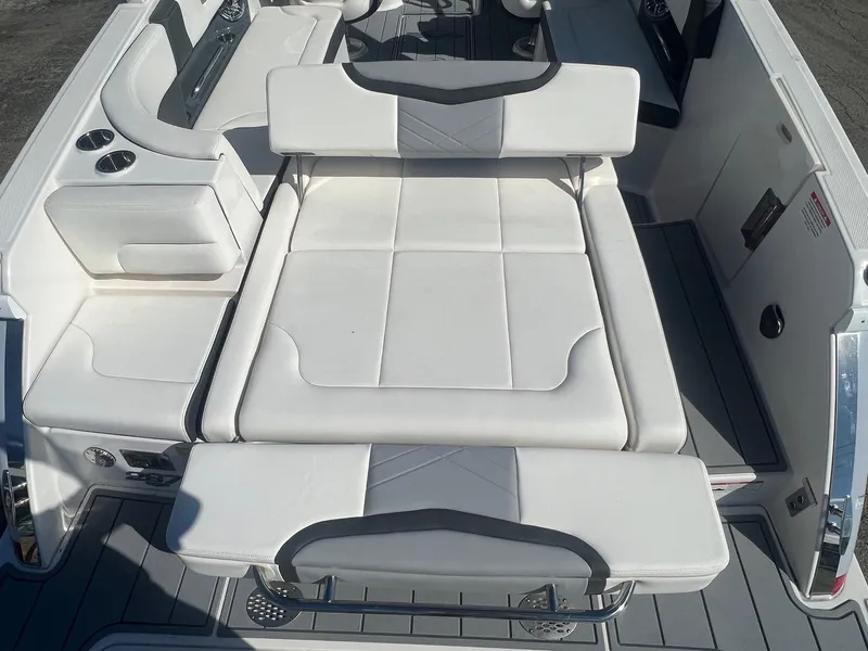 Slide: The Image of 2024 Chaparral 287 SSX boat interior with white seating and cup holders. - 11