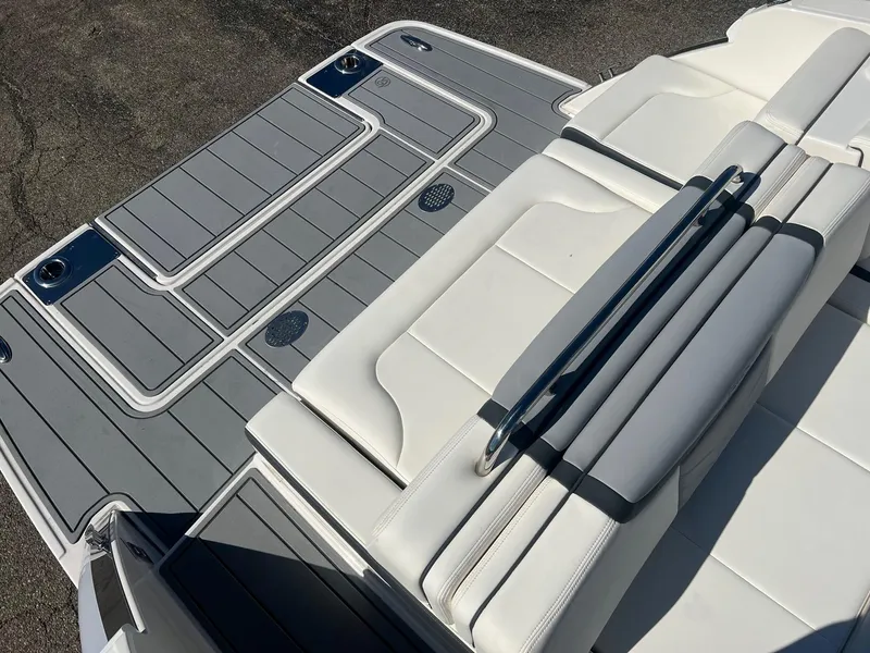 Slide: The Image of 2024 Chaparral 287 SSX boat with sleek white seating and gray deck. - 2