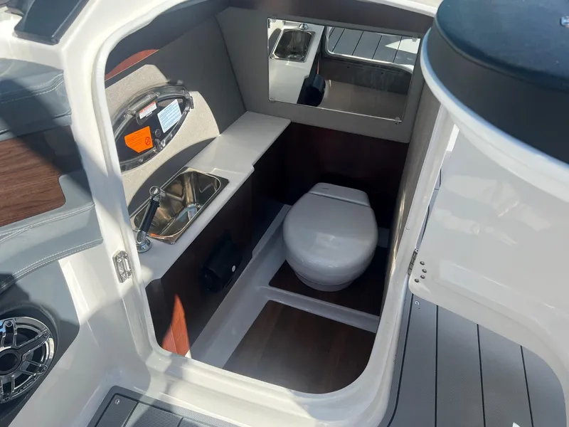Slide: The Image of 2024 Chaparral 287 SSX boat interior with sink and toilet. - 7