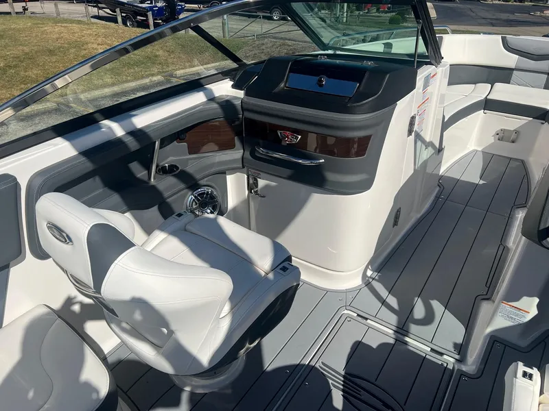 Slide: The Image of 2024 Chaparral 287 SSX boat interior with sleek helm and comfortable seating. - 8