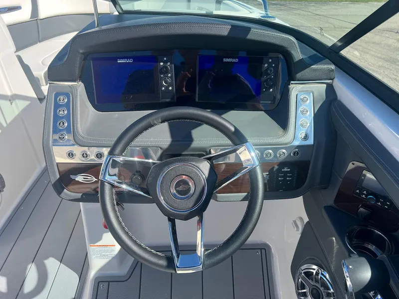 Slide: The Image of 2024 Chaparral 287 SSX dashboard with dual displays and sleek steering wheel. - 9
