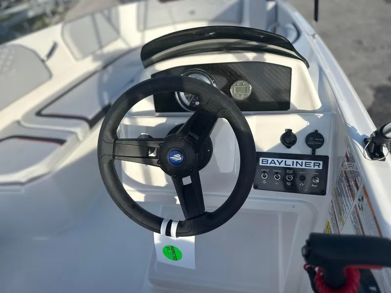Slide: The Image of 2024 Bayliner Element M15 boat steering console and dashboard. - 2
