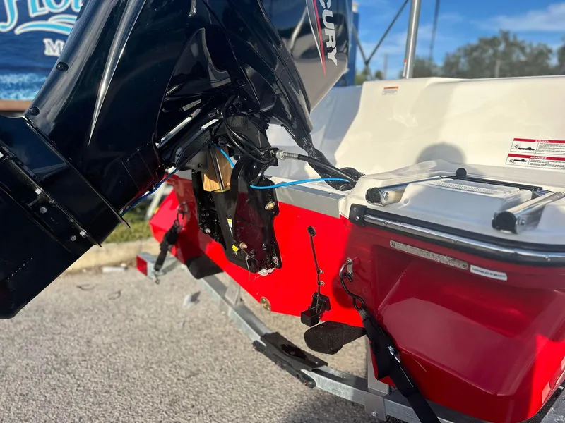 Slide: The Image of 2024 Bayliner Element M15 boat with Mercury outboard motor, red and white hull. - 4