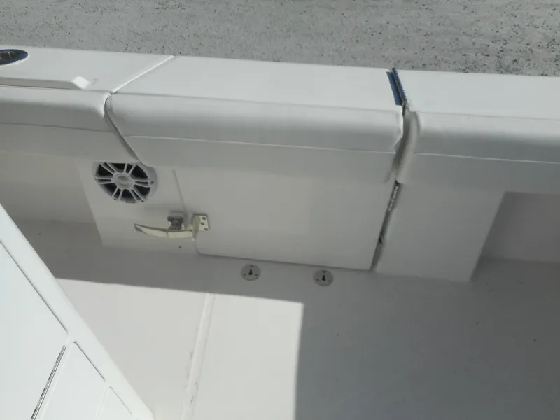 Slide: The Image of 2023 Regulator 34 boat interior with cushioned seating and speaker. - 24