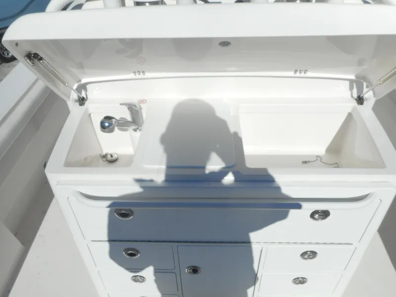 Slide: The Image of 2023 Regulator 34 boat sink and storage compartments. - 6