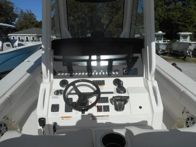 Slide: The Image of 2023 Regulator 34 boat helm with steering wheel and control panel. - 7