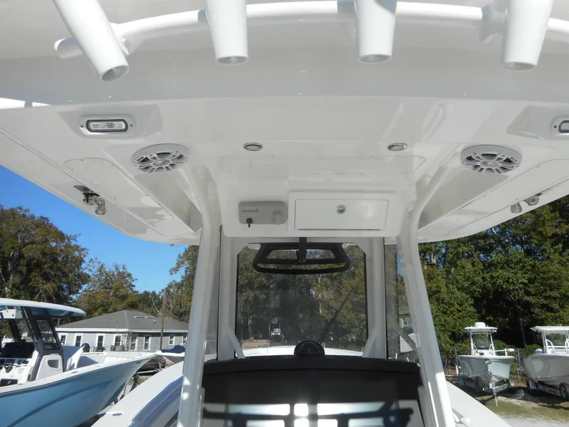 Slide: The Image of 2023 Regulator 34 boat interior with T-top and rod holders. - 8