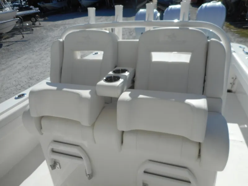 Slide: The Image of 2023 Regulator 34 boat with dual white cushioned seats and cup holders. - 9