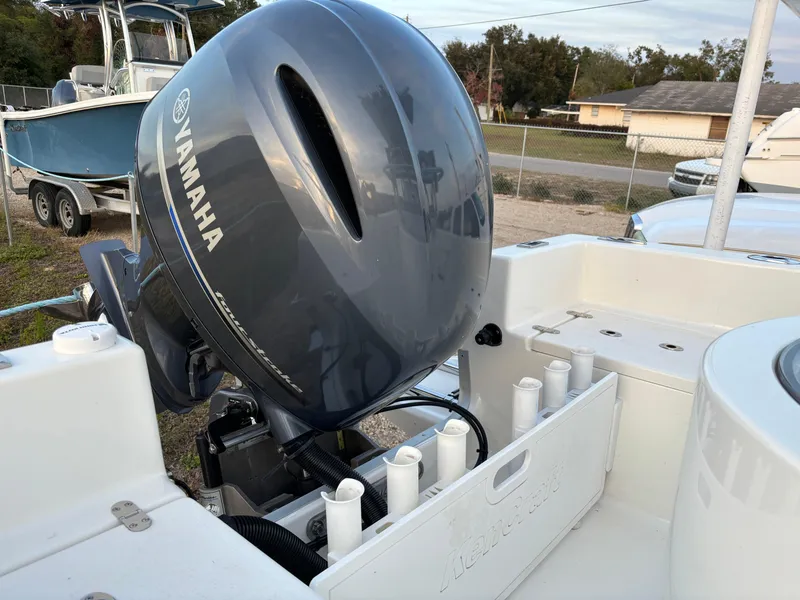 Slide: The Image of KenCraft 21 boat with Yamaha outboard motor, 2021 model, docked outdoors. - 10