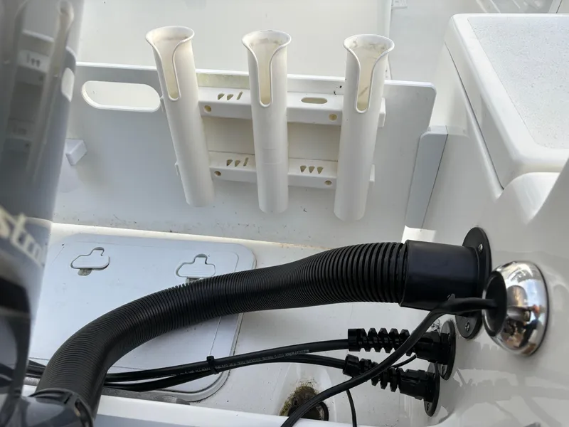 Slide: The Image of KenCraft 21 boat interior, 2021 model, featuring rod holders and wiring details. - 13