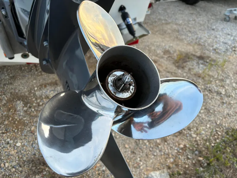 Slide: The Image of KenCraft 21 boat propeller, 2021 model, shiny metal finish, on gravel surface. - 18