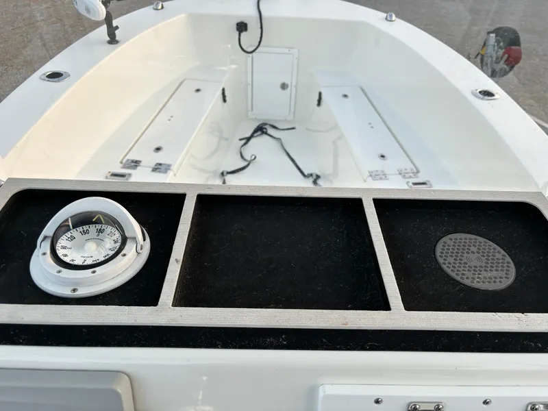 Slide: The Image of KenCraft 21 boat interior, 2021 model, featuring a compass and storage compartments. - 28