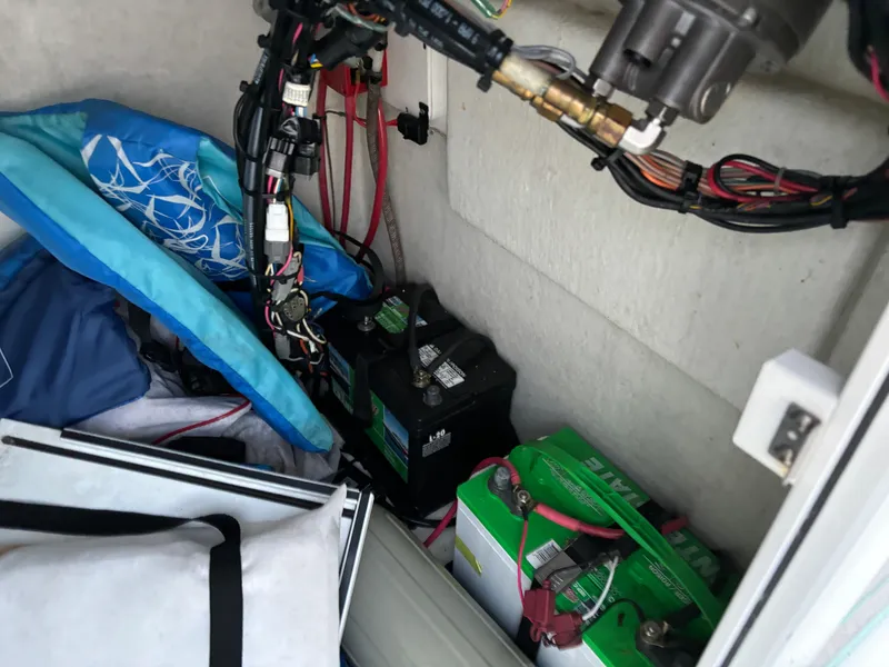 Slide: The Image of Interior of a 2021 KenCraft 21 boat showing batteries and wiring. - 35