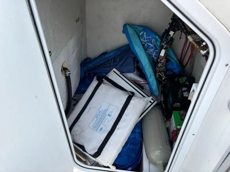 Slide: The Image of Storage compartment of a 2021 KenCraft 21 boat with various equipment and supplies. - 36
