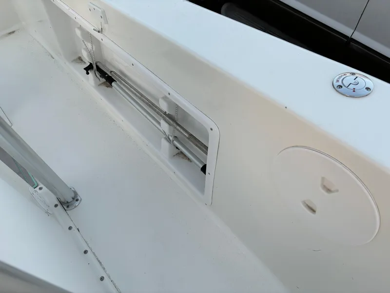 Slide: The Image of 2021 KenCraft 21 boat interior, featuring a clean white deck and storage compartment. - 37