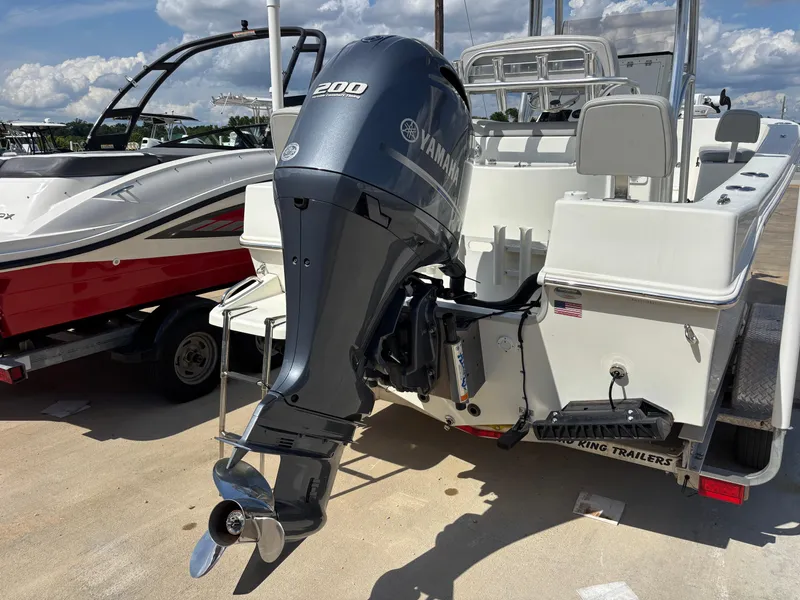 Slide: The Image of KenCraft 21 boat (2021) with Yamaha 200 outboard motor, parked on a trailer. - 4
