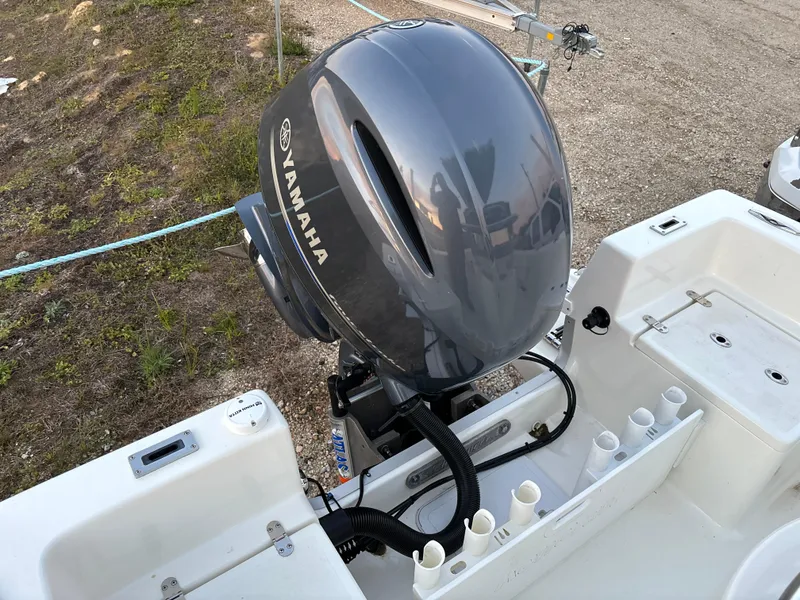 Slide: The Image of KenCraft 21 boat with Yamaha outboard motor, 2021 model, parked on gravel. - 47