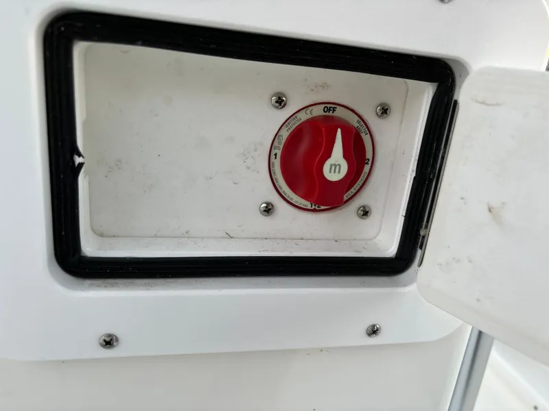Slide: The Image of Red switch on a 2021 KenCraft 21 boat control panel. - 48