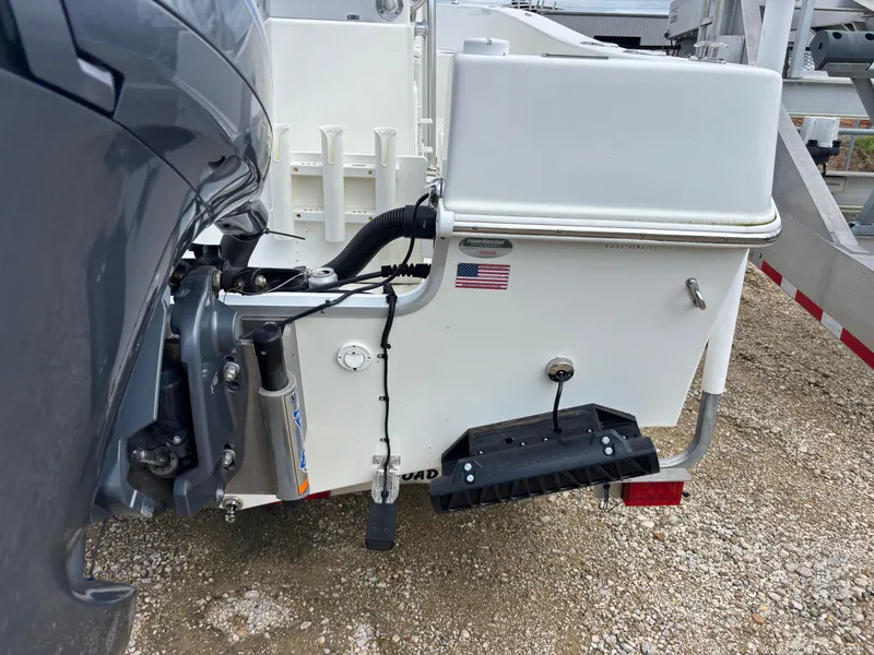 Slide: The Image of KenCraft 21 boat rear view, 2021 model, with motor and American flag decal. - 6