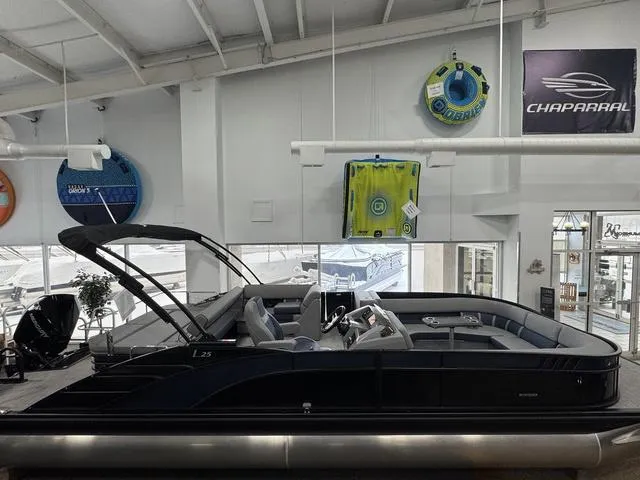 Slide: The Image of 2024 Bennington 25 LTSB pontoon boat in a showroom. - 1
