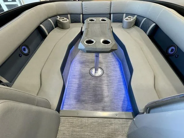 Slide: The Image of 2024 Bennington 25 LTSB boat interior with plush seating and LED lighting. - 11