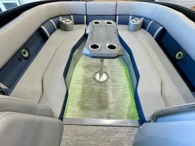 Slide: The Image of 2024 Bennington 25 LTSB boat interior with gray seating and blue LED lighting. - 12
