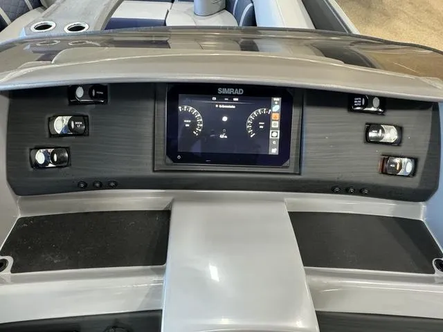 Slide: The Image of 2024 Bennington 25 LTSB boat interior with plush seating and ambient purple lighting. - 13