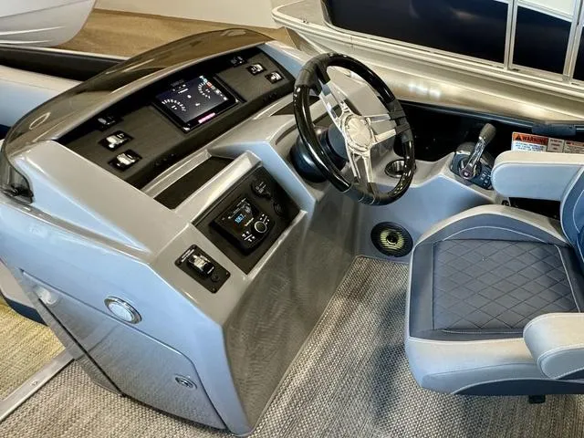 Slide: The Image of 2024 Bennington 25 LTSB pontoon boat interior with luxurious seating and modern design. - 16