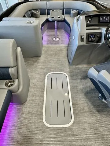 Slide: The Image of 2024 Bennington 25 LTSB boat dashboard with modern steering wheel and digital controls. - 19