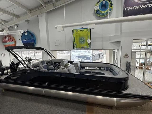 Slide: The Image of 2024 Bennington 25 LTSB pontoon boat in a showroom. - 2