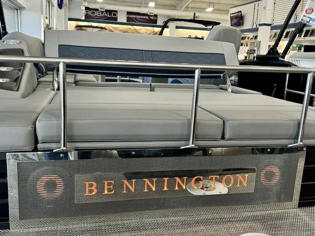 Slide: The Image of 2024 Bennington 25 LTSB boat interior with plush seating and modern dashboard. - 22