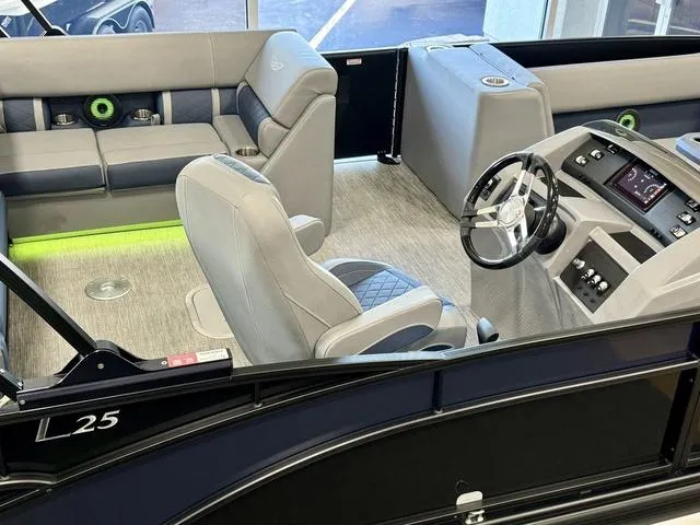 Slide: The Image of 2024 Bennington 25 LTSB pontoon boat with black cover in a showroom. - 6