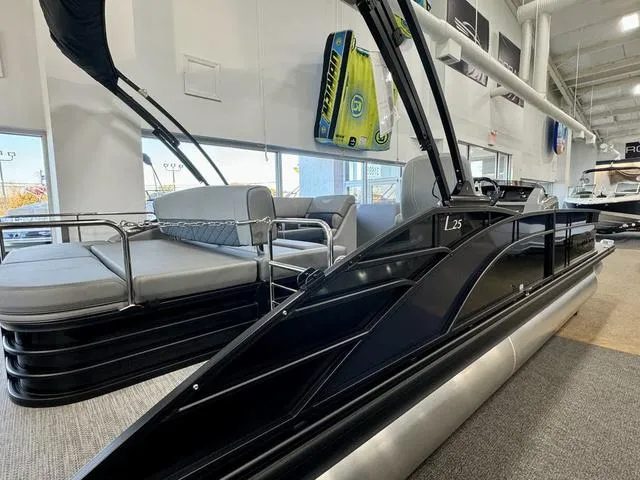 Slide: The Image of 2024 Bennington 25 LTSB storage compartment with a secured metal rod. - 9