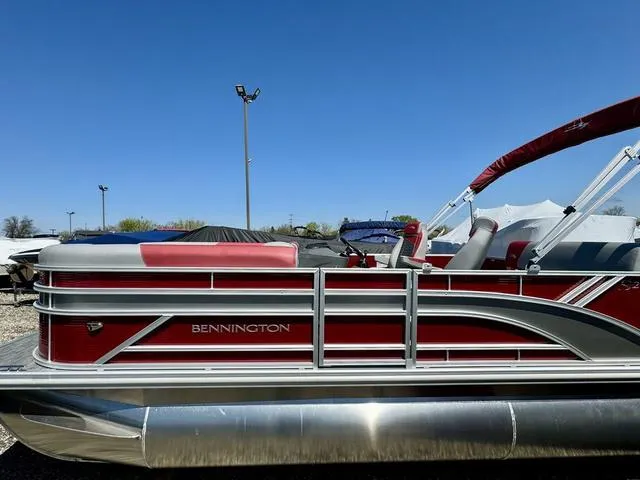 Slide: The Image of 2024 Bennington 20 SSB pontoon boat with red and silver accents. - 1
