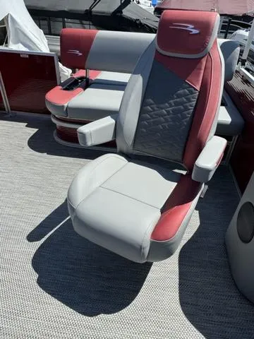 Slide: The Image of 2024 Bennington 20 SSB boat interior with red and gray seating. - 12