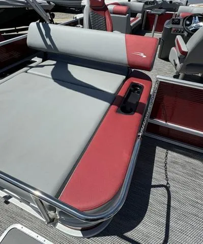 Slide: The Image of 2024 Bennington 20 SSB pontoon boat with red and gray seating. - 16